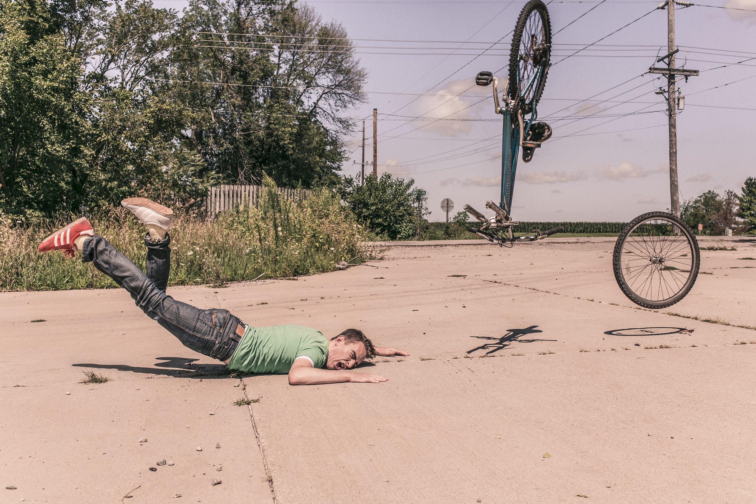Guy wiping out on a bike.