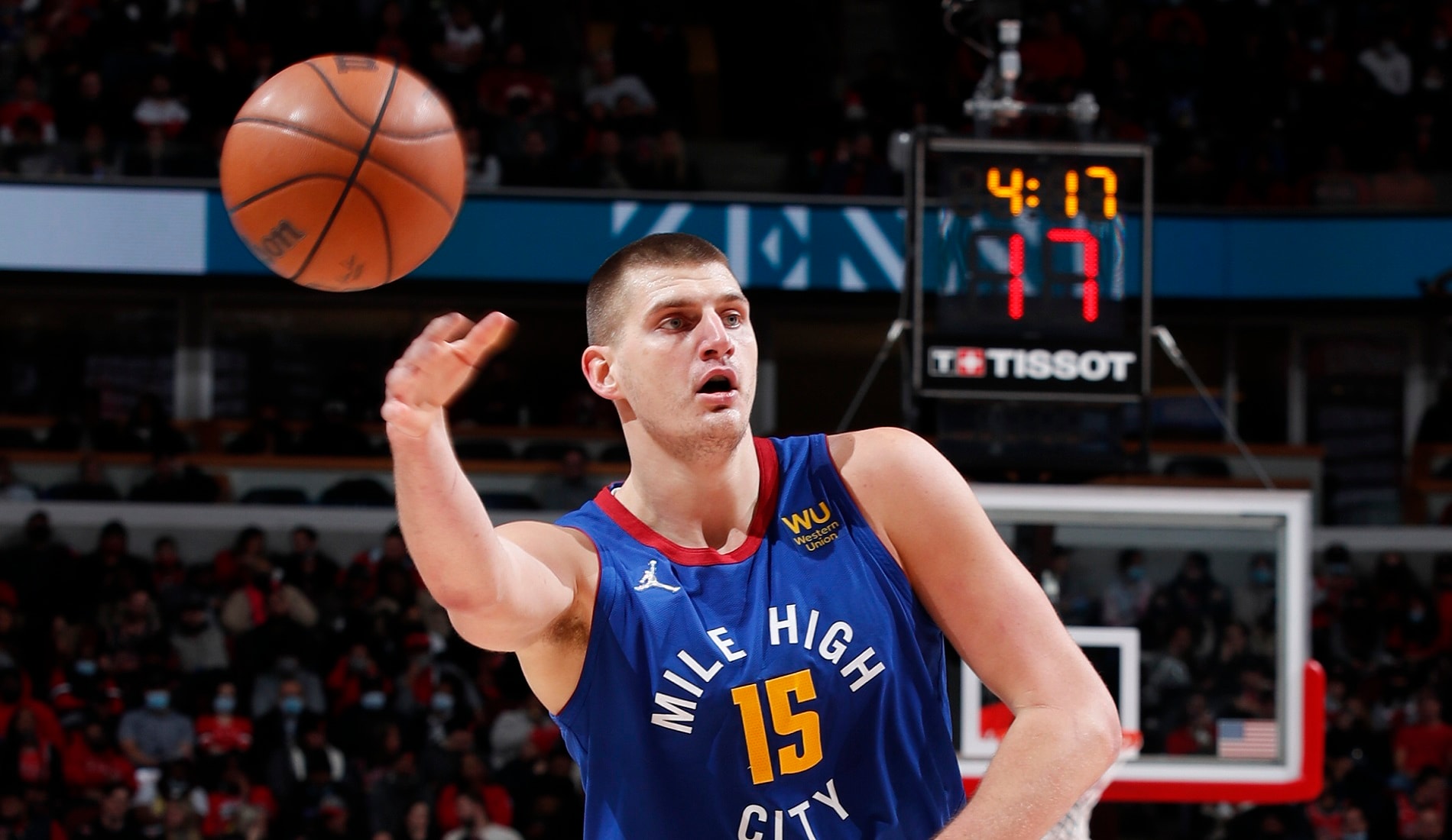 This is a picture from NBA.com of Nikola Jokić passing a basketball.